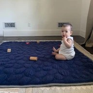 Baby sitting up on Navy Blue Nook Lilypad2 Best Baby and Toddler Play mat
